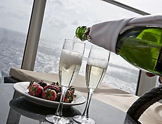 room-service-bottle-glass-champagne-strawberries-balcony